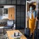 Beautiful afro woman with protective face mask arriving in hotel room