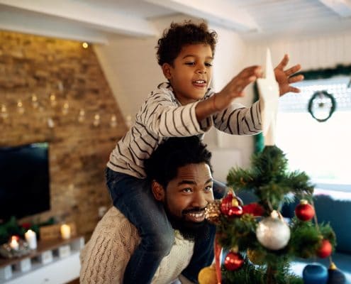 Airbnb Holiday Pricing - father with his son decorating